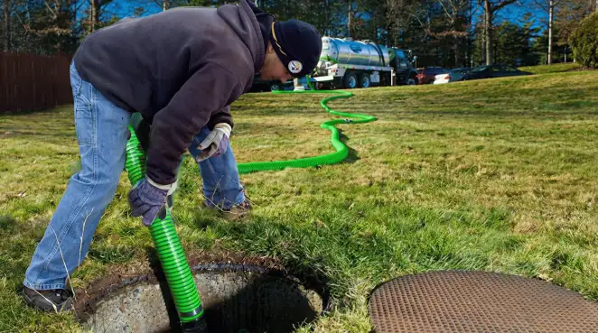 Service technician performing residential septic pumping and drainage maintenance in Minneapolis, MN
